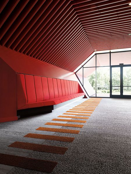 interior having red and white colored carpet tiles on floors